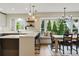 Modern kitchen features sleek white countertops, stainless steel appliances, a bay window, and dining area at 2011 S Gray Dr, Lakewood, CO 80227