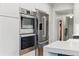 Modern kitchen with stainless steel appliances, sleek white countertops, and ample storage at 2011 S Gray Dr, Lakewood, CO 80227