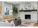 Cozy living room featuring a fireplace, hardwood floors, and plenty of natural light at 2011 S Gray Dr, Lakewood, CO 80227