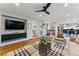 Open-concept living area leading to bar, dining, and kitchen with fireplace at 2011 S Gray Dr, Lakewood, CO 80227