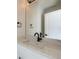 Modern bathroom with white cabinets, white marble-style countertop and black hardware and accents at 1462 Yates St, Denver, CO 80204
