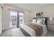Bedroom features large window with balcony, modern decor and neutral color palette at 1462 Yates St, Denver, CO 80204