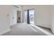 Bedroom features modern sliding door, closet, and balcony access with light gray carpeting at 1462 Yates St, Denver, CO 80204