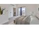 Light-filled bedroom with balcony access, large closet, and neutral carpeting at 1462 Yates St, Denver, CO 80204