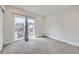 Bright bedroom featuring neutral carpet, large sliding glass door, and lots of natural light at 1462 Yates St, Denver, CO 80204