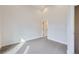 An open concept bedroom featuring modern gray carpet and a white wall at 1462 Yates St, Denver, CO 80204