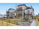 Modern townhouses with multi-level balconies, fenced yards, and xeriscaped landscaping at 1462 Yates St, Denver, CO 80204