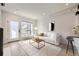 Open-concept living room featuring hardwood floors, a large window and stylish modern decor at 1462 Yates St, Denver, CO 80204