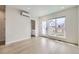 Bright living room with hardwood floors and large window offering plenty of natural light and an attached bath at 1462 Yates St, Denver, CO 80204