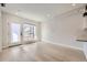 Empty open-concept living room featuring hardwood floors, a large window and bright white walls at 1462 Yates St, Denver, CO 80204