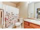 Bathroom featuring a shower/tub combo with a flower curtain and wood vanity at 22920 E Roxbury Dr # H, Aurora, CO 80016