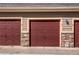 Close-up of garage doors with stone accents; each door has letter designation at 22920 E Roxbury Dr # H, Aurora, CO 80016