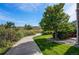A sidewalk leading to a house with tree-filled landscaping at 22920 E Roxbury Dr # H, Aurora, CO 80016