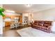 Spacious living area with an adjacent kitchen and laundry space, plus stylish wood flooring and neutral decor at 22920 E Roxbury Dr # H, Aurora, CO 80016