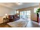 Cozy living room with access to a balcony, featuring a comfortable couch and stylish décor at 22920 E Roxbury Dr # H, Aurora, CO 80016