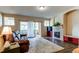 Inviting living room with a fireplace, hardwood floors, a large plush rug and a sliding glass door to the balcony at 22920 E Roxbury Dr # H, Aurora, CO 80016