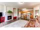 Open-concept living space with a fireplace, wood floors, a cozy rug, and a kitchen area featuring a wooden island at 22920 E Roxbury Dr # H, Aurora, CO 80016