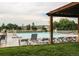 Relaxing view of community pool with plenty of lounge seating, deck, and trees at 22920 E Roxbury Dr # H, Aurora, CO 80016