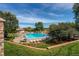 Overhead view of community pool surrounded by manicured lawn and lounge seating at 22920 E Roxbury Dr # H, Aurora, CO 80016