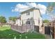 Exterior view showing a backyard with a well-kept lawn and a spacious deck at 3982 S Himalaya Way, Aurora, CO 80013