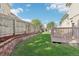 The backyard features a wooden fence and a brick-lined garden at 3982 S Himalaya Way, Aurora, CO 80013