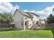 View of a well-manicured lawn in the backyard with a two-story house and a deck at 3982 S Himalaya Way, Aurora, CO 80013