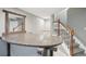Basement bar with granite countertop, wooden mirror, and stairwell at 3982 S Himalaya Way, Aurora, CO 80013