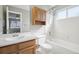 Bathroom showcasing a shower-tub combo with a bright vanity, storage, and a mirror at 3982 S Himalaya Way, Aurora, CO 80013