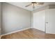 Neutral bedroom with hardwood floors, a ceiling fan, and closet space for storage at 3982 S Himalaya Way, Aurora, CO 80013