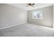 Bedroom with neutral walls, new carpet, a ceiling fan, and a sunny window at 3982 S Himalaya Way, Aurora, CO 80013