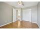 Bedroom with hardwood floors, neutral paint, and closet space with a view of the bathroom at 3982 S Himalaya Way, Aurora, CO 80013