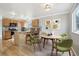 A dining area with wood cabinets, granite countertops, stainless steel appliances, and a dining table at 3982 S Himalaya Way, Aurora, CO 80013