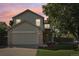 Charming two-story home with a well-kept lawn, attached garage, and inviting front porch at 3982 S Himalaya Way, Aurora, CO 80013