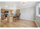 A kitchen with wood cabinets, granite countertops, stainless steel appliances, and hardwood floors at 3982 S Himalaya Way, Aurora, CO 80013
