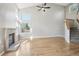 Bright living room with hardwood floors, a fireplace, and large windows creating a welcoming space at 3982 S Himalaya Way, Aurora, CO 80013
