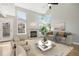 Bright and airy living room featuring a cozy fireplace, neutral décor, and ample natural light at 3982 S Himalaya Way, Aurora, CO 80013