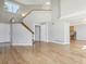 Bright, open living room features hardwood floors, staircase, and view into the kitchen at 3982 S Himalaya Way, Aurora, CO 80013