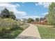 A scenic neighborhood path leads to a beautiful home under a bright sky with fluffy clouds at 3982 S Himalaya Way, Aurora, CO 80013