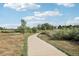 A well-maintained pathway winds through a neighborhood, offering a scenic route for outdoor strolls at 3982 S Himalaya Way, Aurora, CO 80013