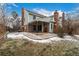 Charming backyard showcasing a covered patio, brick accents, and landscaped yard, perfect for outdoor living and entertaining at 7501 S Ivanhoe Cir, Centennial, CO 80112