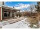 Scenic backyard featuring a covered patio and well-maintained lawn, providing a relaxing outdoor space for leisure and enjoyment at 7501 S Ivanhoe Cir, Centennial, CO 80112