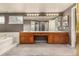Bathroom featuring a long vanity with dual sinks, walk in closet, and shower at 7501 S Ivanhoe Cir, Centennial, CO 80112