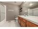 Bathroom featuring a shower, toilet, vanity, and mirror at 7501 S Ivanhoe Cir, Centennial, CO 80112
