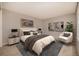 Comfortable bedroom with neutral tones, stylish furniture, and artistic decor at 7501 S Ivanhoe Cir, Centennial, CO 80112