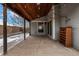 Inviting covered patio with a wood ceiling and stylish lighting, creating a cozy and comfortable outdoor living space at 7501 S Ivanhoe Cir, Centennial, CO 80112