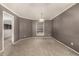 An empty dining room boasts neutral colors and a large window, offering a bright and versatile space at 7501 S Ivanhoe Cir, Centennial, CO 80112