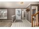 Inviting foyer with tile flooring, a staircase, and a view into the living spaces at 7501 S Ivanhoe Cir, Centennial, CO 80112