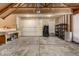 Well-organized garage with ample storage, a workbench, and overhead lighting, providing a functional space for projects and parking at 7501 S Ivanhoe Cir, Centennial, CO 80112