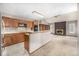 Open kitchen featuring wood cabinets, bar seating, and a fireplace in an expansive layout at 7501 S Ivanhoe Cir, Centennial, CO 80112