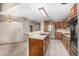 Bright kitchen showcases an island with modern fixtures and wood cabinetry, offering a functional space at 7501 S Ivanhoe Cir, Centennial, CO 80112